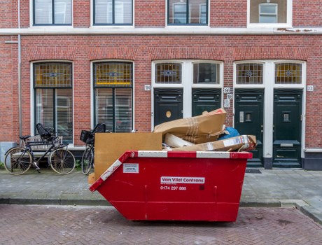 Enclosed skip stationed in a residential area of Euston