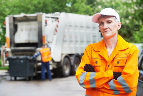 Stack of labelled skip hire and man-and-van vans parked ready